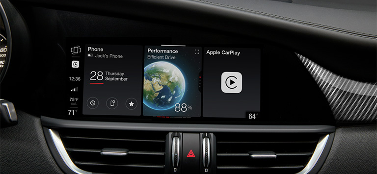 The Uconnect touchscreen and heating and cooling vents in a 2026 Alfa Romeo Giulia.
